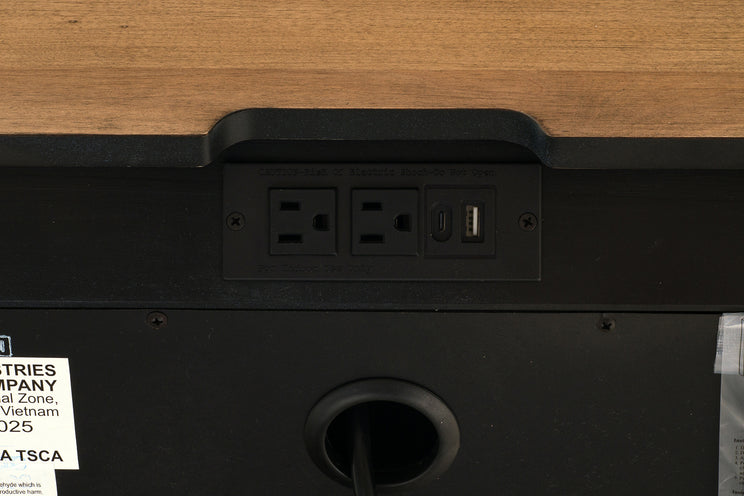 Power strip with multiple outlets and a USB port on a wooden surface